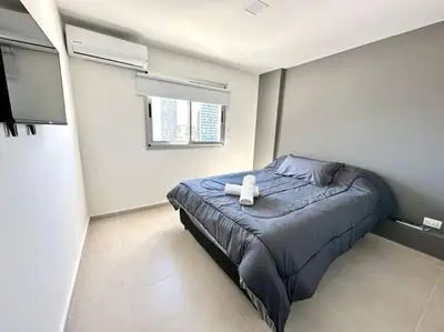 a bedroom with a bed with a teddy bear on it at Departamento p 4 personas F Gral Paz in Cordoba