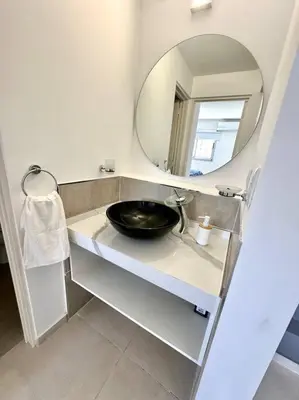 a bathroom with a sink and a mirror at Departamento p 4 personas F Gral Paz in Cordoba