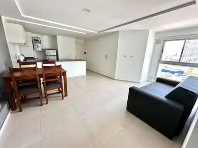 a living room with a couch and a table at Departamento p 4 personas F Gral Paz in Cordoba