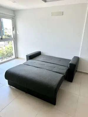 a black bed in a room with a window at Departamento p 4 personas F Gral Paz in Cordoba