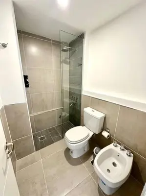 a small bathroom with a toilet and a shower at Departamento p 4 personas F Gral Paz in Cordoba