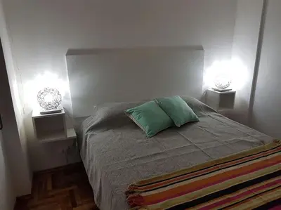 a bedroom with a bed with two lamps on it at Achaval Nueva Córdoba Apartment in Cordoba