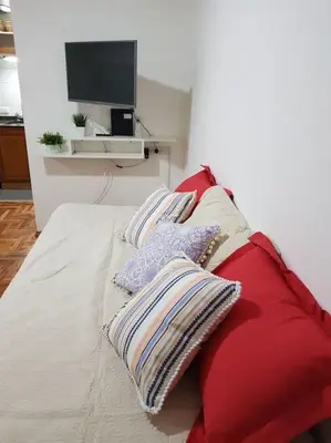 a couch with pillows and a television in a room at Achaval Nueva Córdoba Apartment in Cordoba