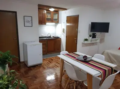 a kitchen with a table and chairs in a room at Achaval Nueva Córdoba Apartment in Cordoba