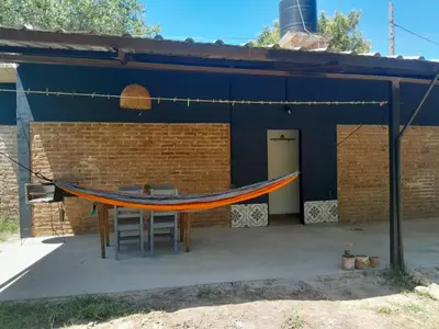a patio with a hammock in front of a building at Casa Azul in Villa del Dique