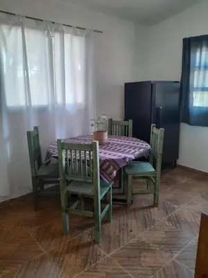 a dining room table and chairs with a purple table cloth at Casa Azul in Villa del Dique