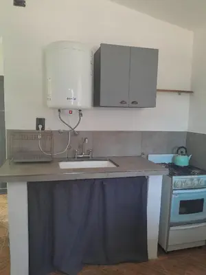 a kitchen counter with a sink and a stove at Casa Azul in Villa del Dique