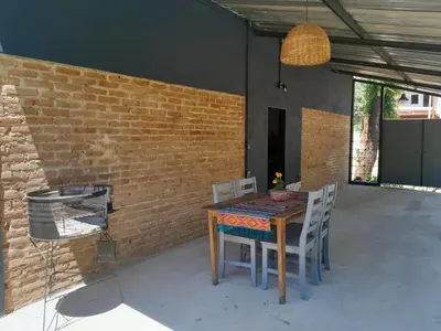 a table and chairs in a patio with a brick wall at Casa Azul in Villa del Dique