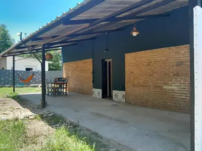 a blue house with a wooden roof and a patio at Casa Azul in Villa del Dique