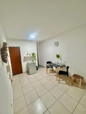a room with a table and chairs and a clock on the wall at Departamento en el corazón de Córdoba in Cordoba
