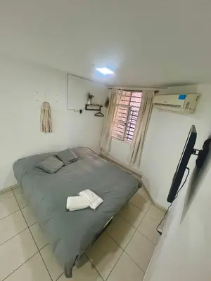 a small bed in a small room with a window at Departamento en el corazón de Córdoba in Cordoba