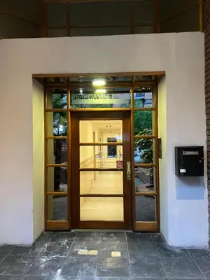 a door to a building with a sign on it at Departamento en el corazón de Córdoba in Cordoba