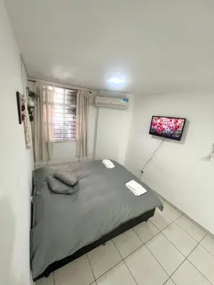 a bedroom with a bed in a room with a window at Departamento en el corazón de Córdoba in Cordoba