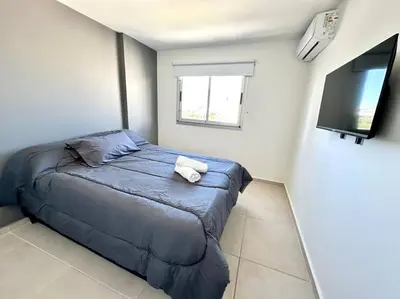 a bedroom with a bed and a flat screen tv at Alojamiento entero para 3 personas D in Cordoba
