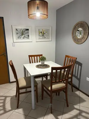 a dining room with a white table and chairs at LA MEJOR UBICACIÓN de NUEVA CÓRDOBA in Cordoba