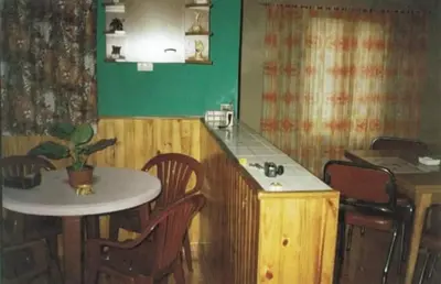 a kitchen with a table and a table and chairs at Casa Con Pileta Exclusiva a 50 mtrs Rio in Villa Carlos Paz