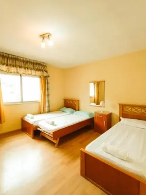 a bedroom with two beds and a window at Edificio en Avenida Libertad in Villa Carlos Paz