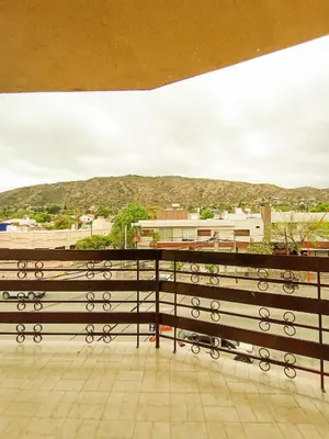 a bench on a balcony with a view of a city at Edificio en Avenida Libertad in Villa Carlos Paz