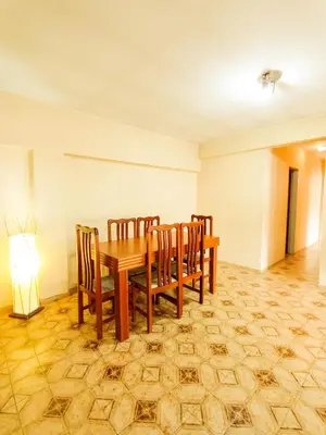 a dining room with a wooden table and chairs at Edificio en Avenida Libertad in Villa Carlos Paz