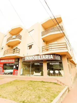 a store front of a building with tables and chairs at Edificio en Avenida Libertad in Villa Carlos Paz
