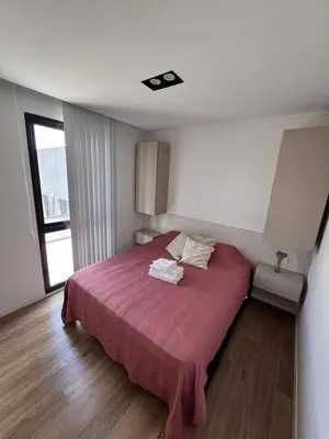 a bedroom with a bed with a pink blanket at Carlos paz resort premium in Villa Carlos Paz