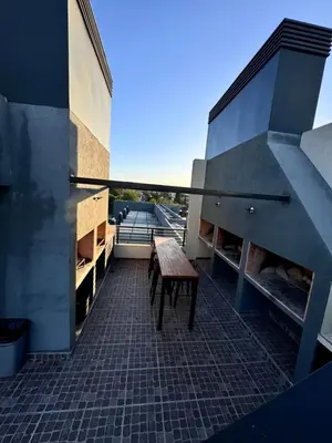 a balcony with a wooden bench on a building at Carlos paz resort premium in Villa Carlos Paz