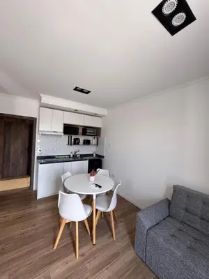 a living room with a table and chairs and a couch at Carlos paz resort premium in Villa Carlos Paz