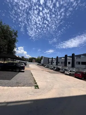 a parking lot with cars parked in front of a building at Carlos paz resort premium in Villa Carlos Paz