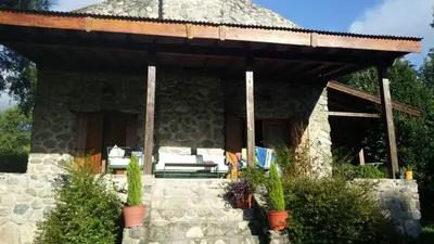 a stone house with a pavilion on a patio at Refugio de las Sierras in Villa General Belgrano