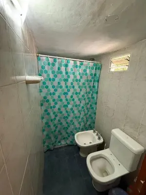 a bathroom with a toilet and a shower and a sink at Casa feliza in Villa Dolores