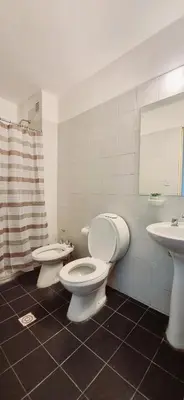 a bathroom with a toilet and a sink at Departamento en la Docta in Cordoba