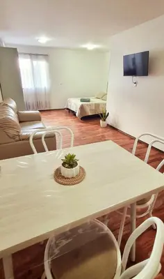 a living room with a table and a couch at Departamento en la Docta in Cordoba