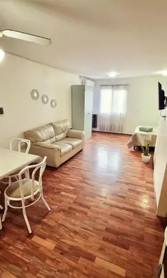a living room with a couch and a table at Departamento en la Docta in Cordoba