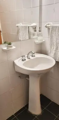 a bathroom with a white sink and a mirror at Departamento en la Docta in Cordoba