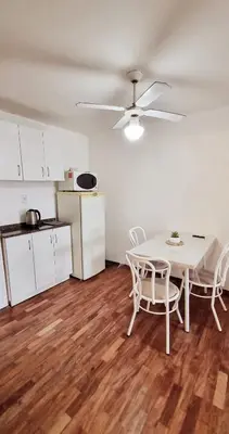 a kitchen and a table and chairs in a room at Departamento en la Docta in Cordoba
