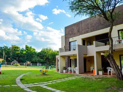 a building with a playground in front of a park at Apart Entrepiedras in Merlo