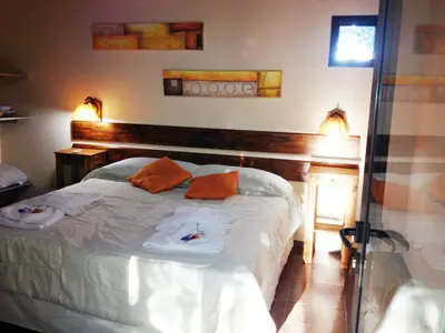a bedroom with a bed with towels on it at Apart Entrepiedras in Merlo