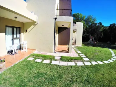 a backyard of a house with a grass yard at Apart Entrepiedras in Merlo