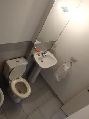 a bathroom with a toilet and a sink at Departamento con FERNET in Cordoba