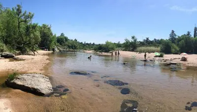 a group of people playing in the water on a beach at Cabaña Tala Huasi in Villa Icho Cruz