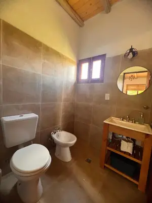a bathroom with a toilet and a sink at Ranchos de la Tata in Las Calles