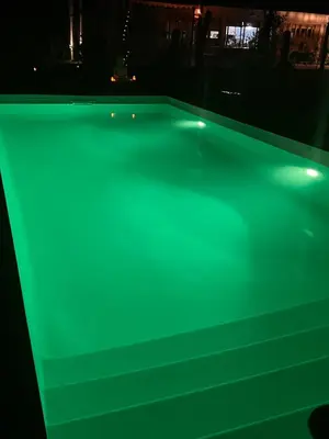 a pool table with green lights on it at Ranchos de la Tata in Las Calles