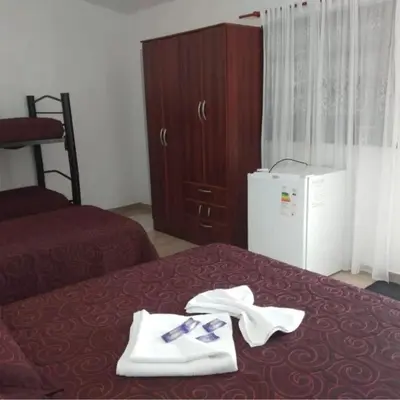 a hotel room with a bed with towels on it at BALCON De LA SIERRA in Las Calles