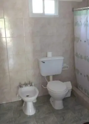 a bathroom with a white toilet and a shower at BALCON De LA SIERRA in Las Calles