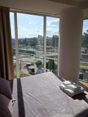 a bedroom with a bed and a large window at Departamento Polanco Tower in Cordoba