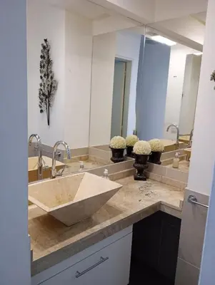 a bathroom with a sink and two mirrors at Departamento Polanco Tower in Cordoba