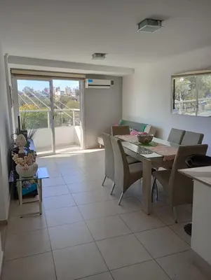 a kitchen and dining room with a table and chairs at Departamento Polanco Tower in Cordoba