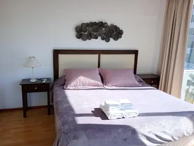 a bedroom with a bed with two towels on it at Departamento Polanco Tower in Cordoba