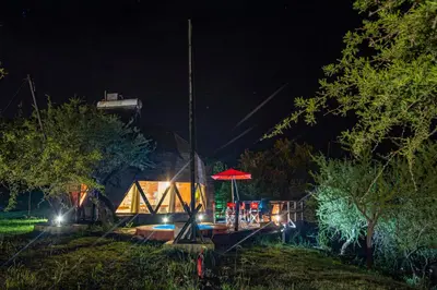 a playground at night with a red umbrella at Domos in Santa Rosa de Calamuchita