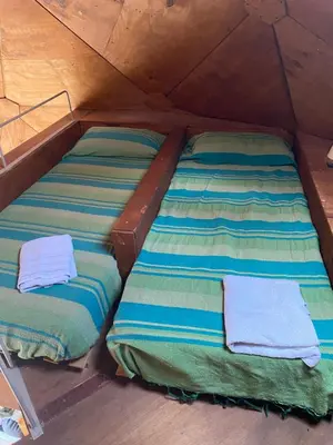 two beds in a tent with towels on them at Domos in Santa Rosa de Calamuchita